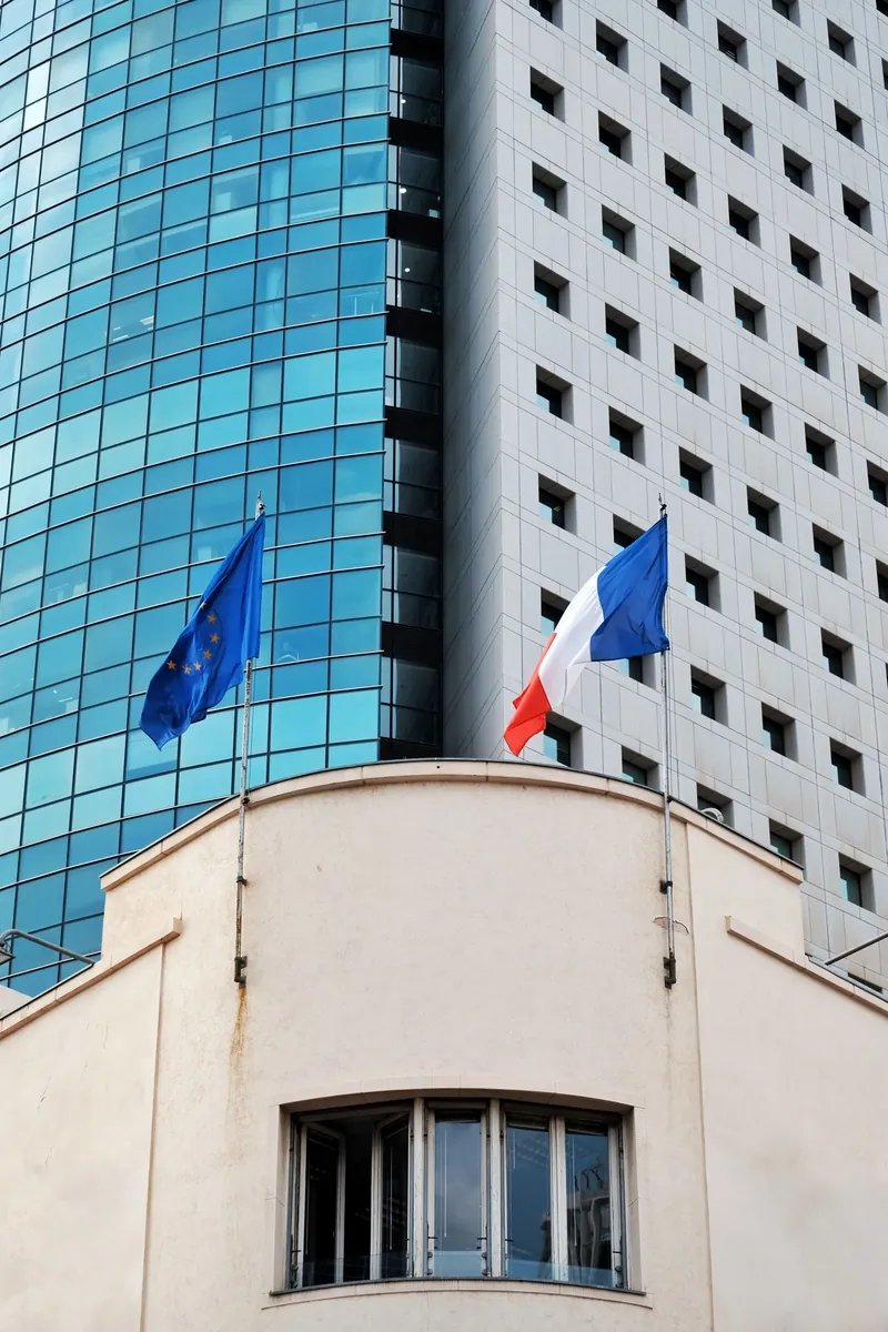 French and European flags on a modern building in France
